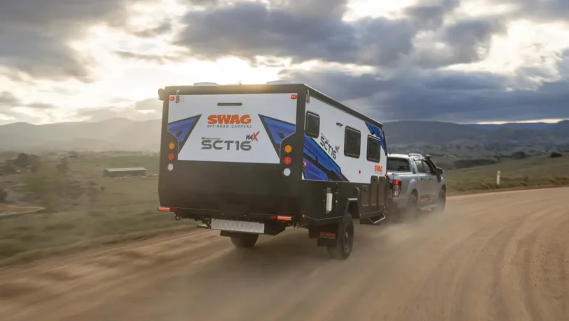 Sct16 G6 Pop Top Couples hybrid caravan driving along dusty road