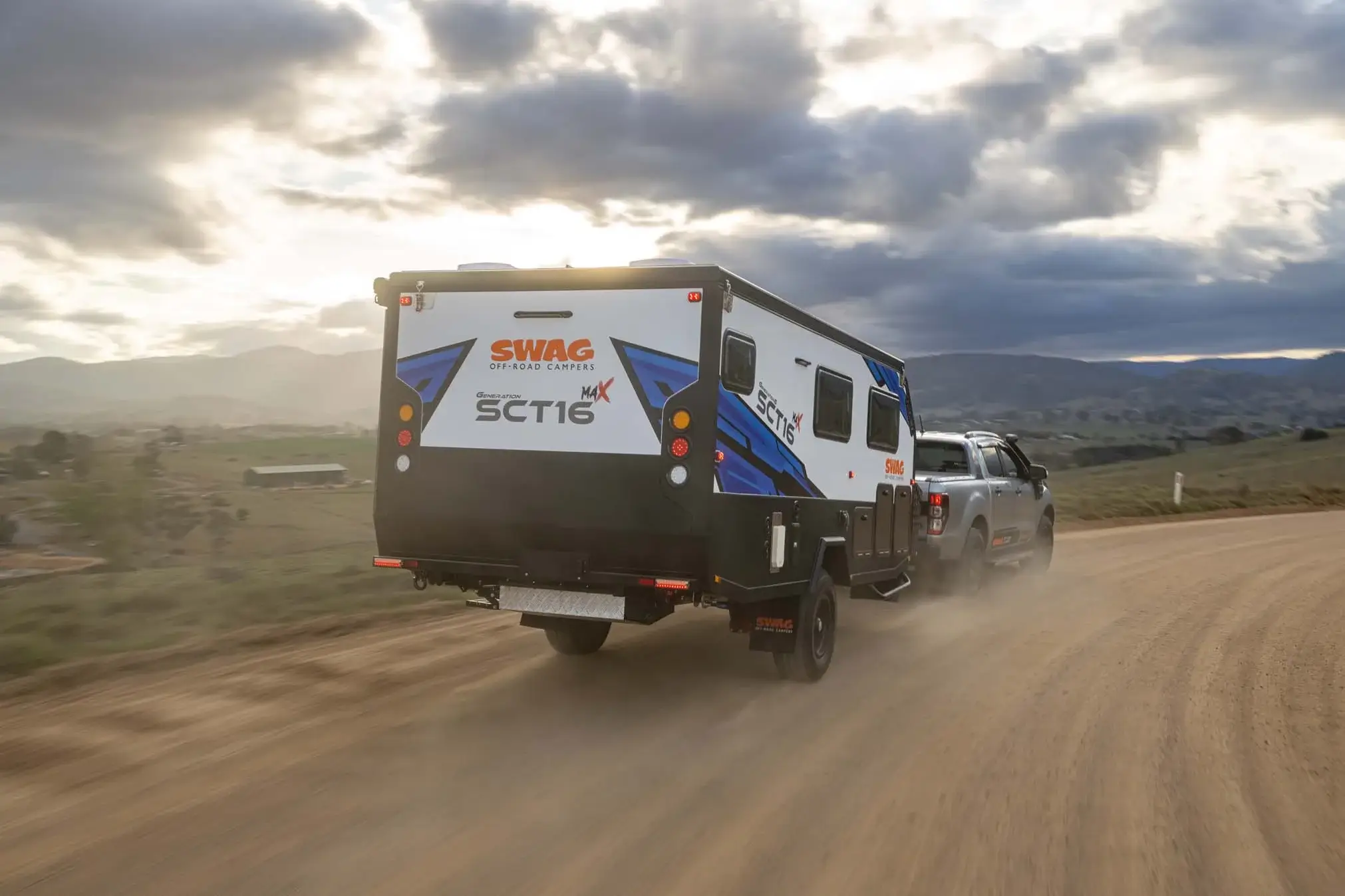 Sct16 G6 Pop Top Couples hybrid caravan driving along dusty road